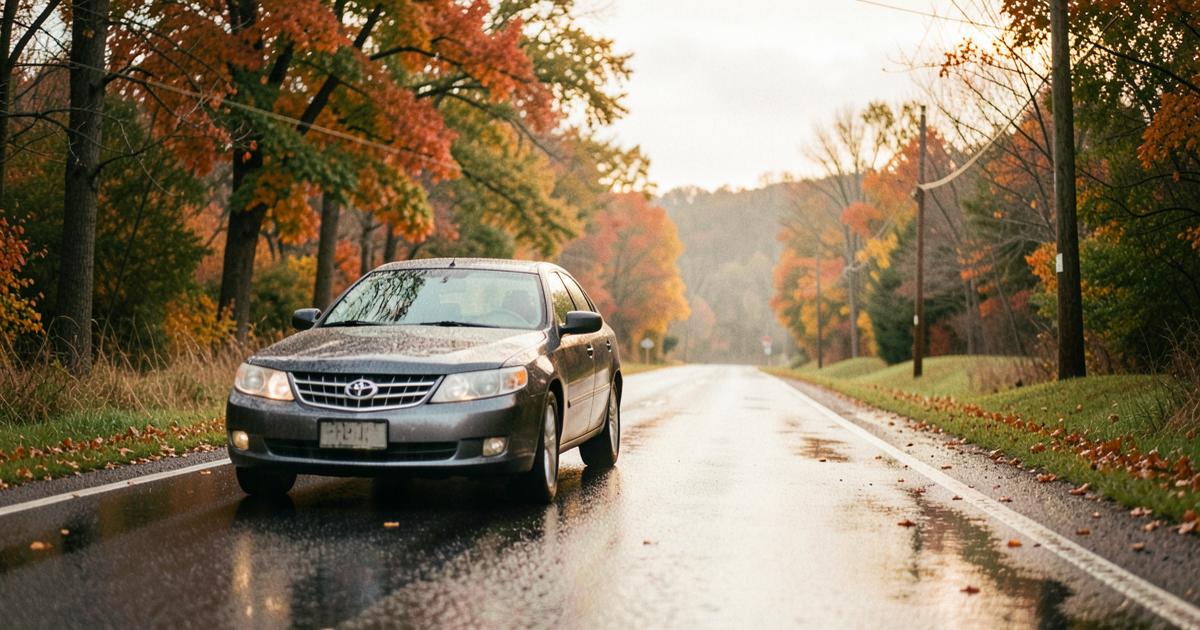 A car on a rain-slicked Pennsylvania road in autumn